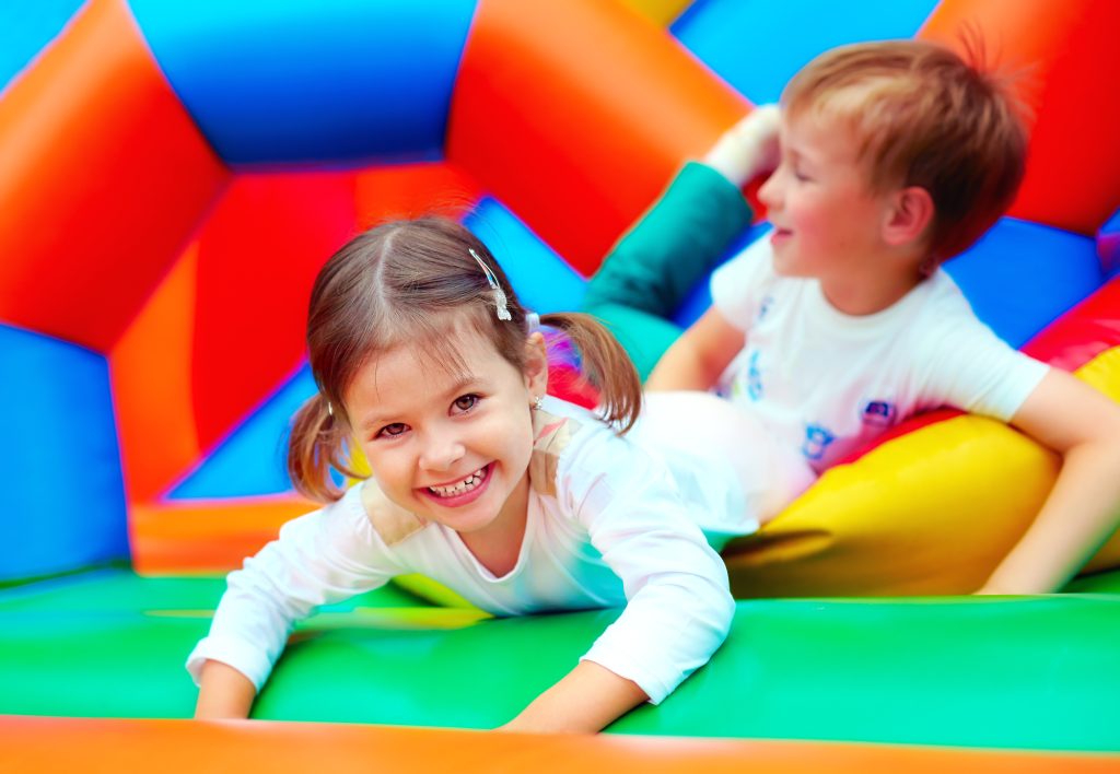 Happy kids having fun in a bounce house.