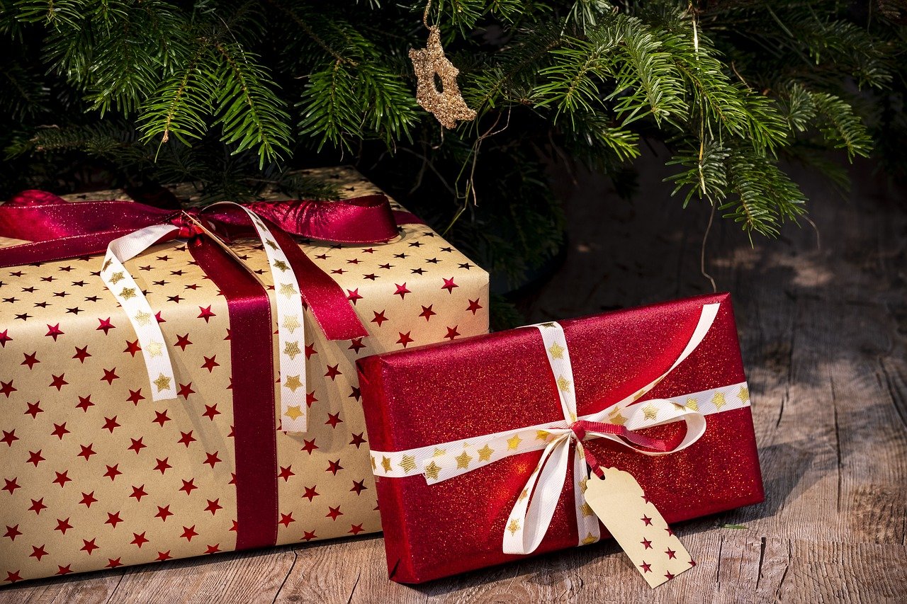 two perfectly wrapped gifts under a tree, stay organized this holiday season