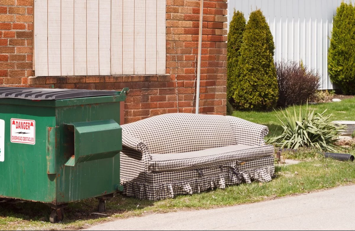 sofa next to dumpster